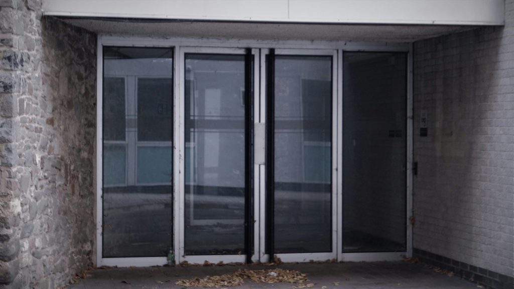 a building with two doors and a brick wall